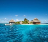 Small tropical island with Beach Villas and speed boat