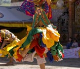 Masked man dancing on a Tsechus - Lumle holidays
